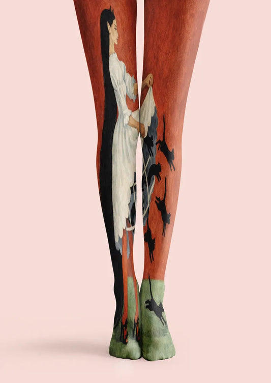 Red printed tights with a painted woman in white and black cat motifs
