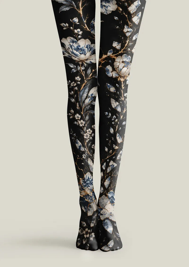 Black printed tights with blue and white porcelain-style floral motifs and branches