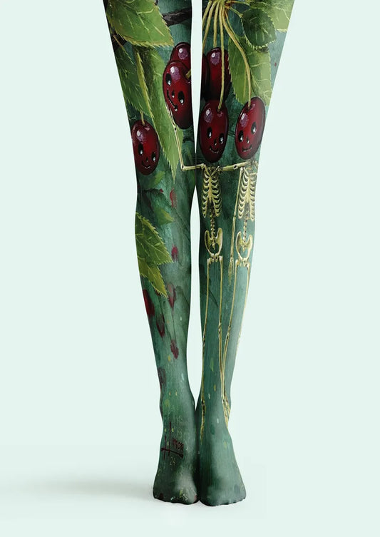 Green printed tights with red cherries, leafy branches, and anatomical illustration details