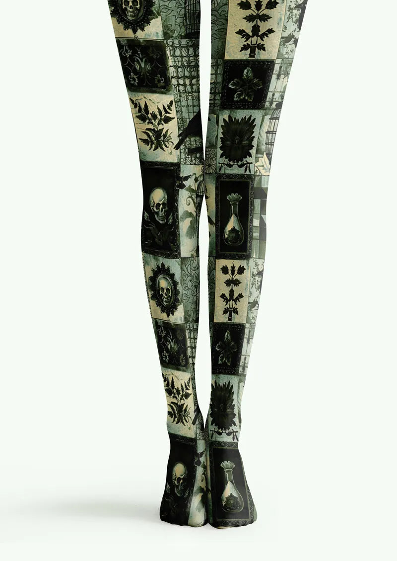 Green printed tights with skull panels, botanical motifs, birds, and gothic object details