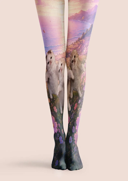 Pink, purple and green printed tights with fluffy kittens, meadow flowers and a pastel mountain landscape