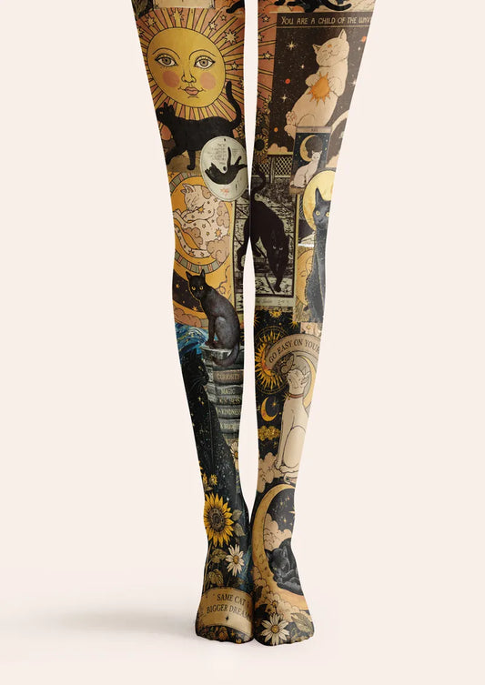 Beige printed tights with black cats, sun, moon, stars, and celestial collage details