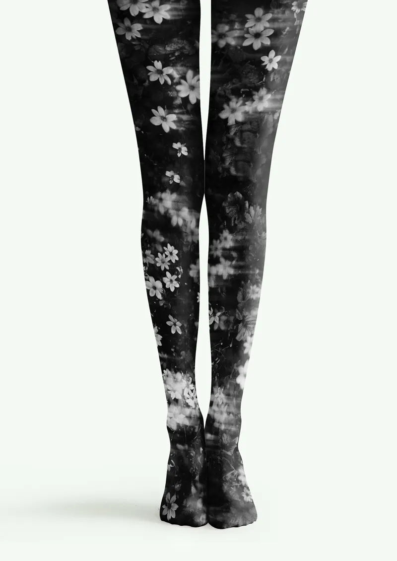 Black and white printed tights with soft-focus floral motifs and layered monochrome blossoms
