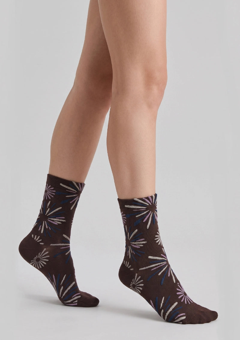 Side view of crew socks with repeating firework-inspired radial burst motifs