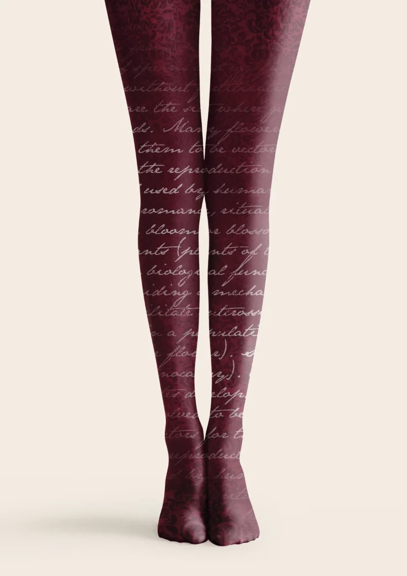 Burgundy printed tights with pale cursive script layered over a dark tonal floral pattern