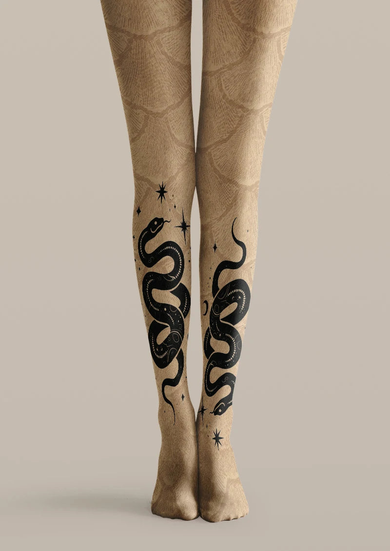 Beige printed tights with large black coiled snake tattoo motifs and small star accents