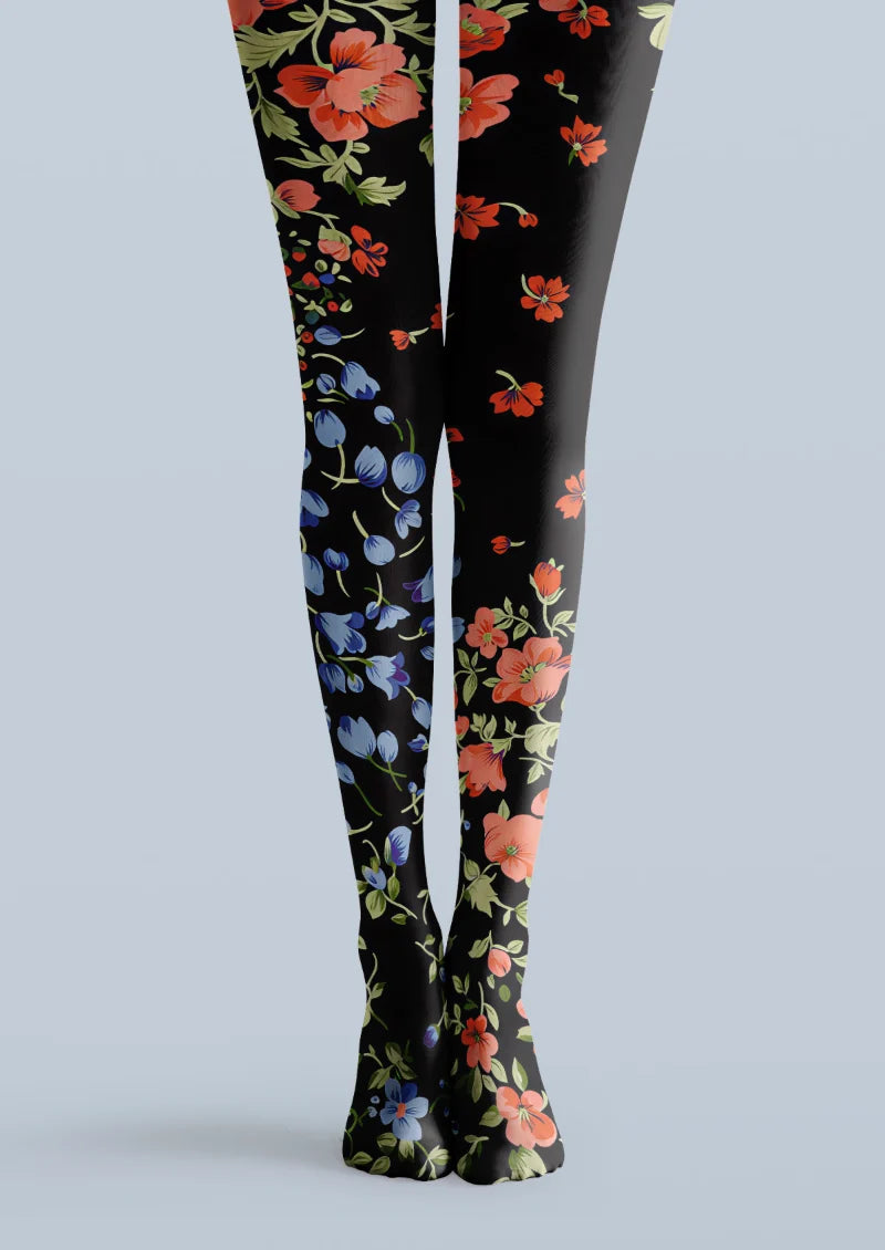Black printed tights with scattered coral-red and blue flowers and green leaves.