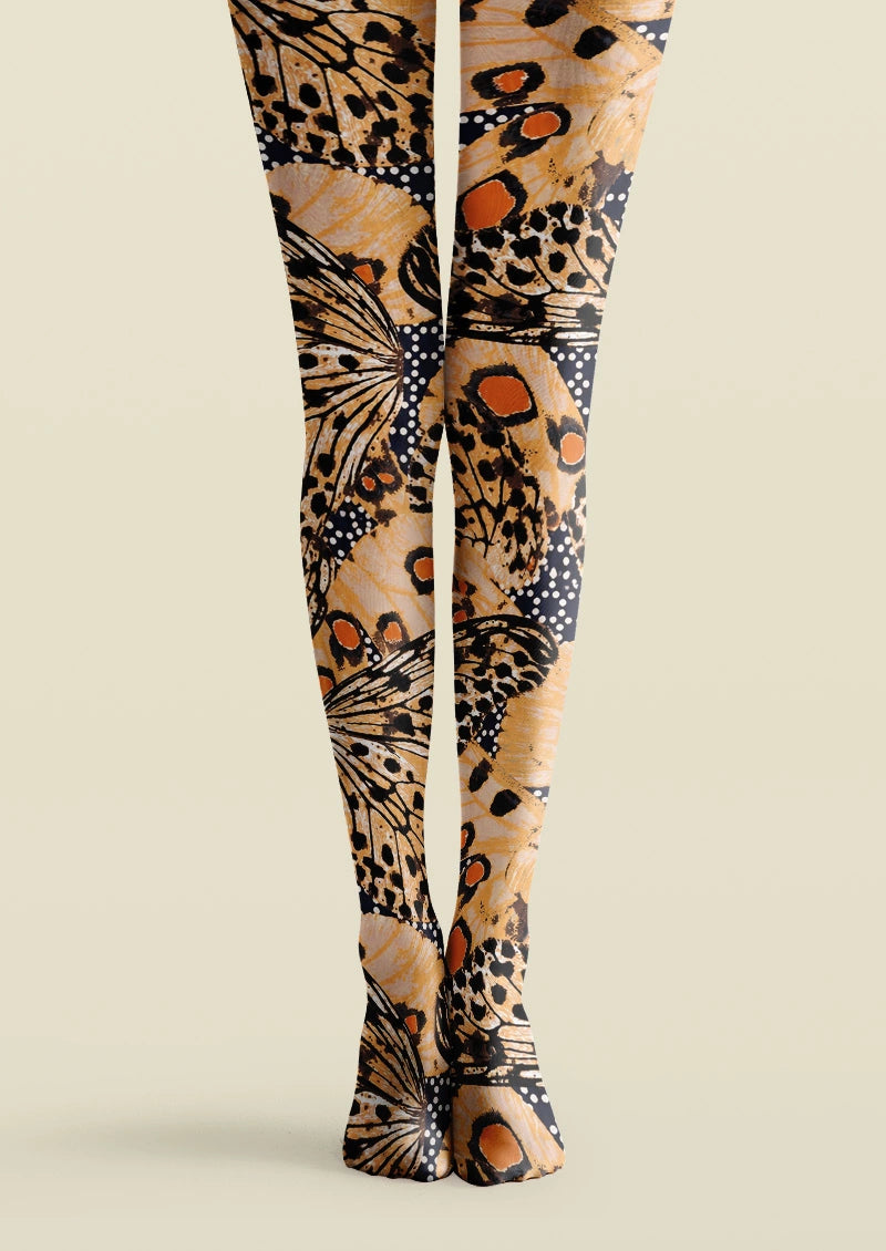 Beige, black, and orange printed tights with oversized butterfly wing motifs