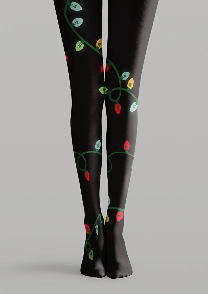 Black printed tights with a looping green cord and illustrated red, yellow, pale blue and green Christmas light bulbs.