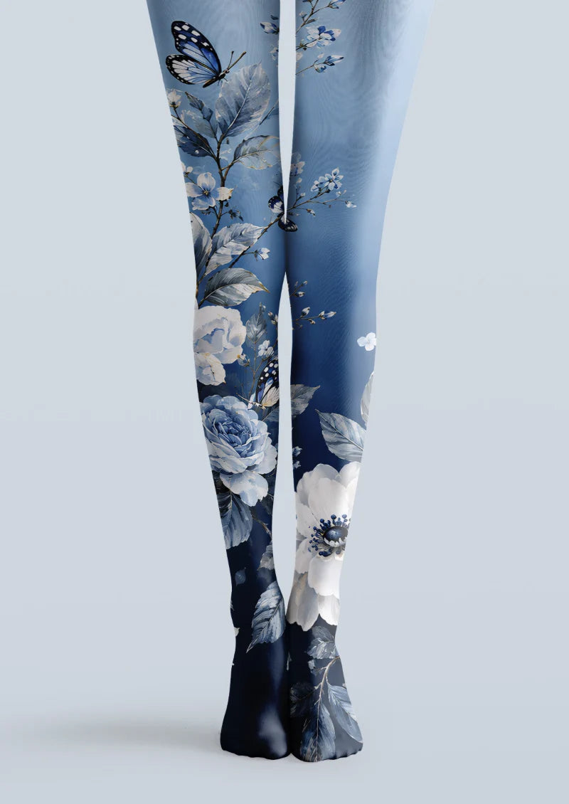 Blue printed tights with white flowers, botanical leaves, butterflies, and deep navy shading.