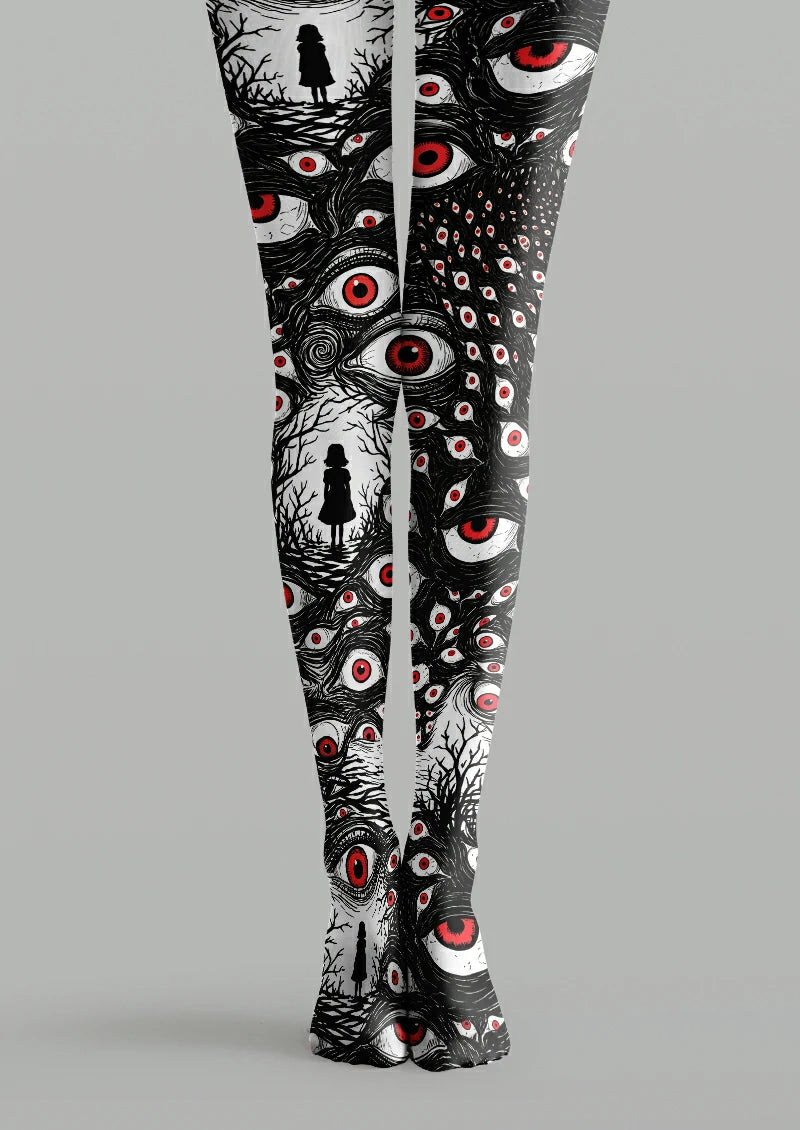 Black printed tights with white eyes, red irises, dense linework and small human silhouettes framed by bare branches.