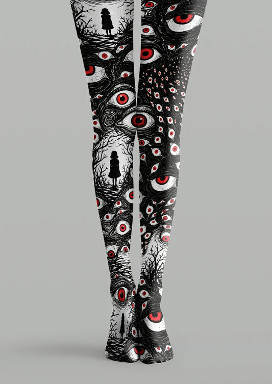 Black printed tights with white eyes, red irises, dense linework and small human silhouettes framed by bare branches.