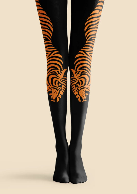 Black tights with paired orange tiger illustrations, striped bodies, curved tails, and tiger faces on the lower legs