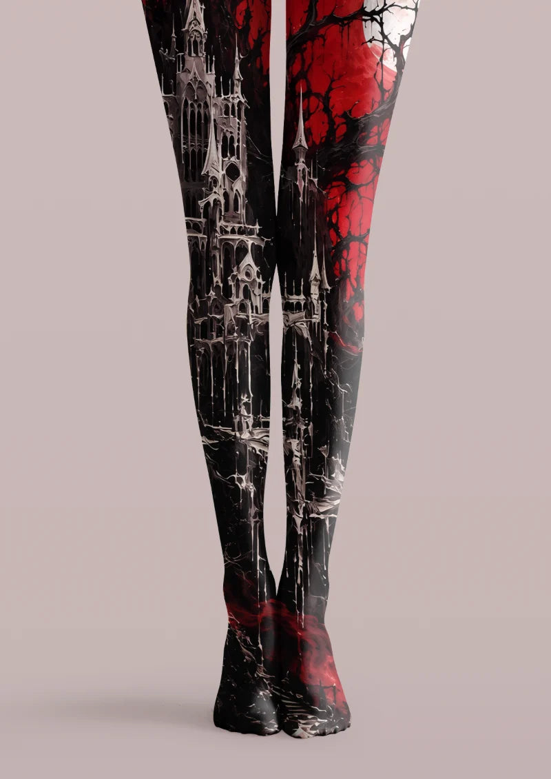 Black and red printed tights with a moonlit castle, bare branches, and gray architectural details across both legs
