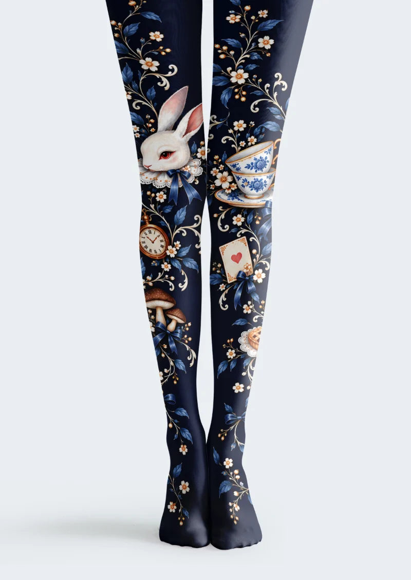 Navy tights with a rabbit, blue floral teacups, a pocket watch, mushrooms, a heart playing card, and floral vines.