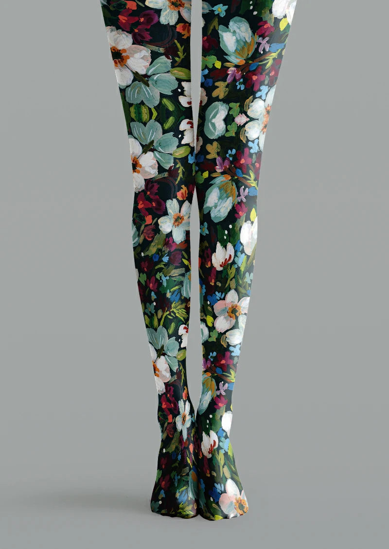 Black printed tights with large white and pale blue flowers, green leaves, orange centres and smaller pink blossoms.