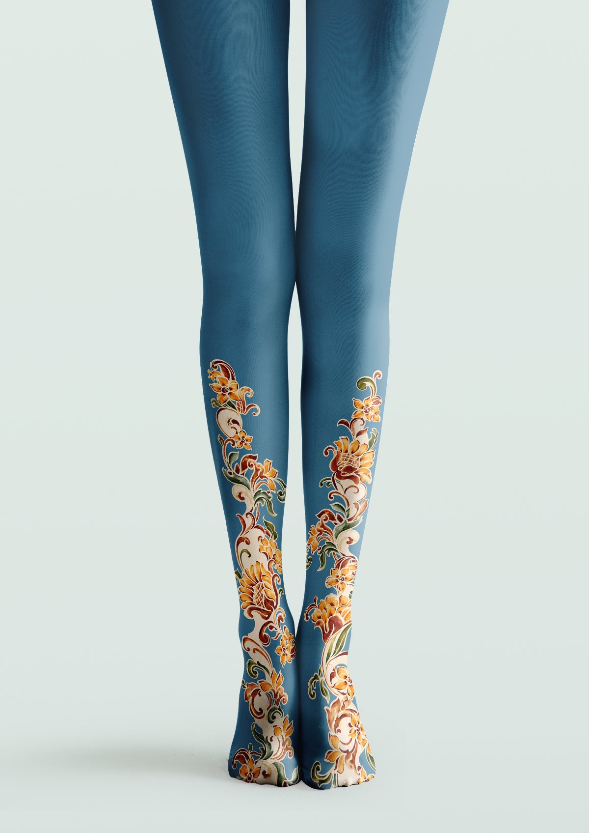 Blue printed tights with orange floral vines, curling stems, green leaves, and cream outlines along the lower legs.