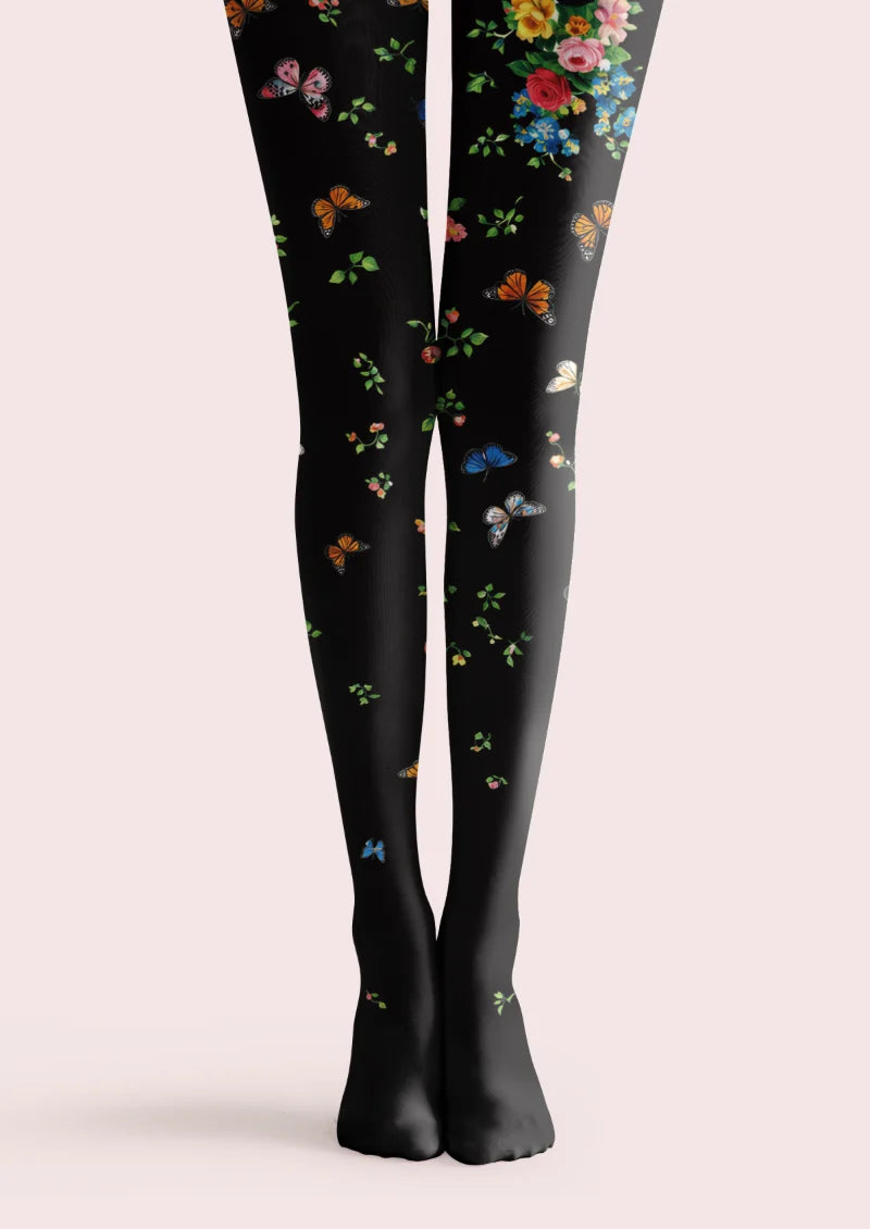 Black tights with colorful roses, green leaves, and scattered butterflies; Marcellise printed tights.