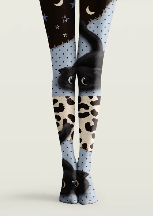 Black, blue, and ivory printed tights with cat illustrations, animal-print panels, polka dots, stars, and crescent moons