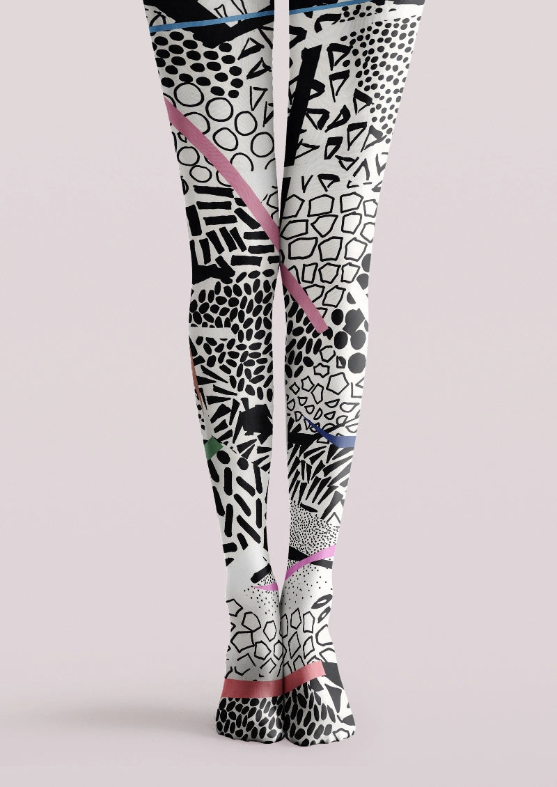 White and black printed tights with abstract geometric marks and pink, blue, and green accents