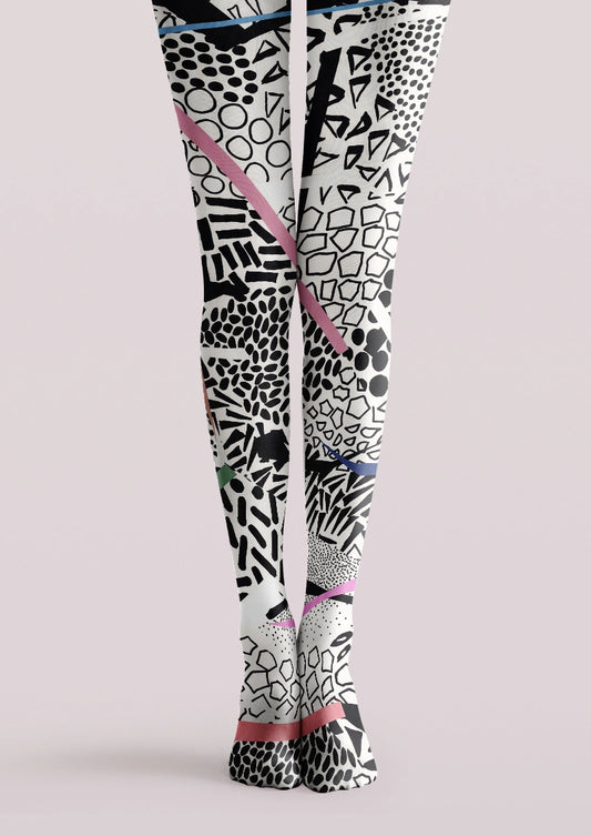 White and black printed tights with abstract geometric marks and pink, blue, and green accents