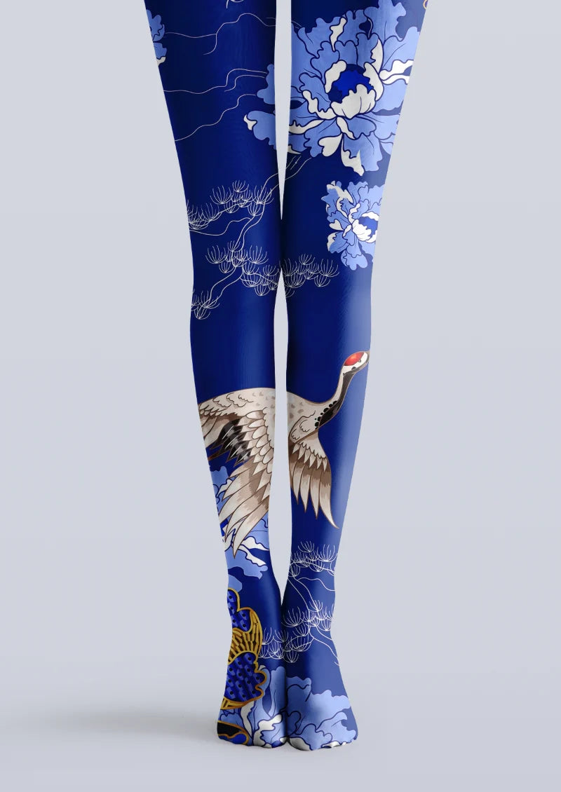 Navy printed tights with a flying crane, blue and white blossoms, and fine botanical branches across both legs