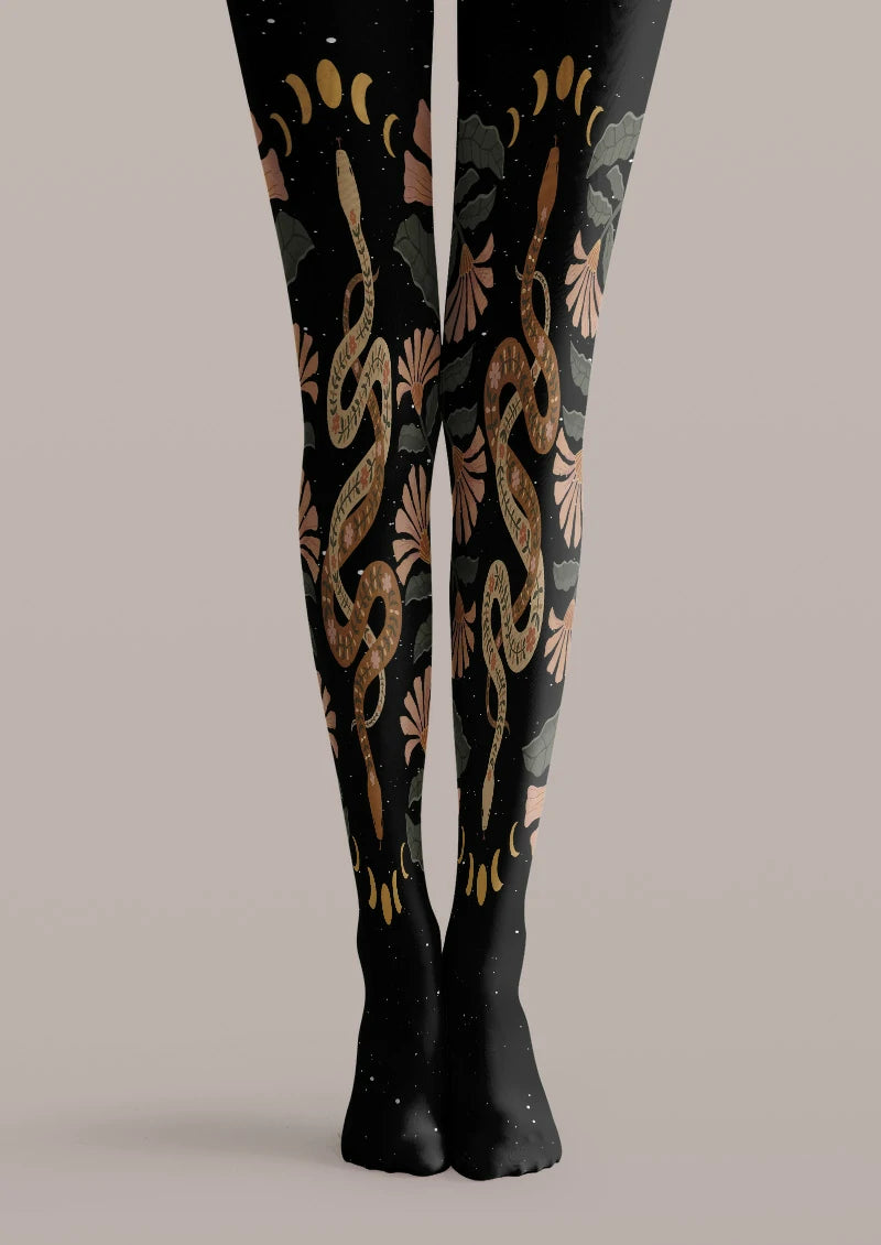 Black printed tights with brown snakes, moon phases, green leaves, and floral accents