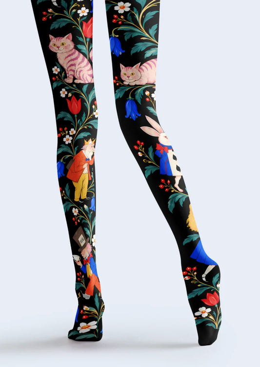 Black tights with pink striped cats, a white rabbit, illustrated characters, teal leaves, and colorful flowers
