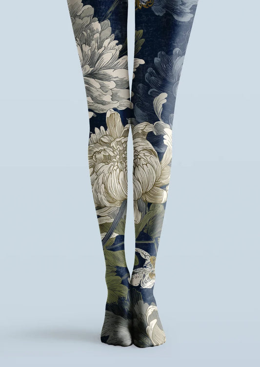 Navy printed tights with oversized ivory flowers, green leaves, and bronze botanical linework across both legs