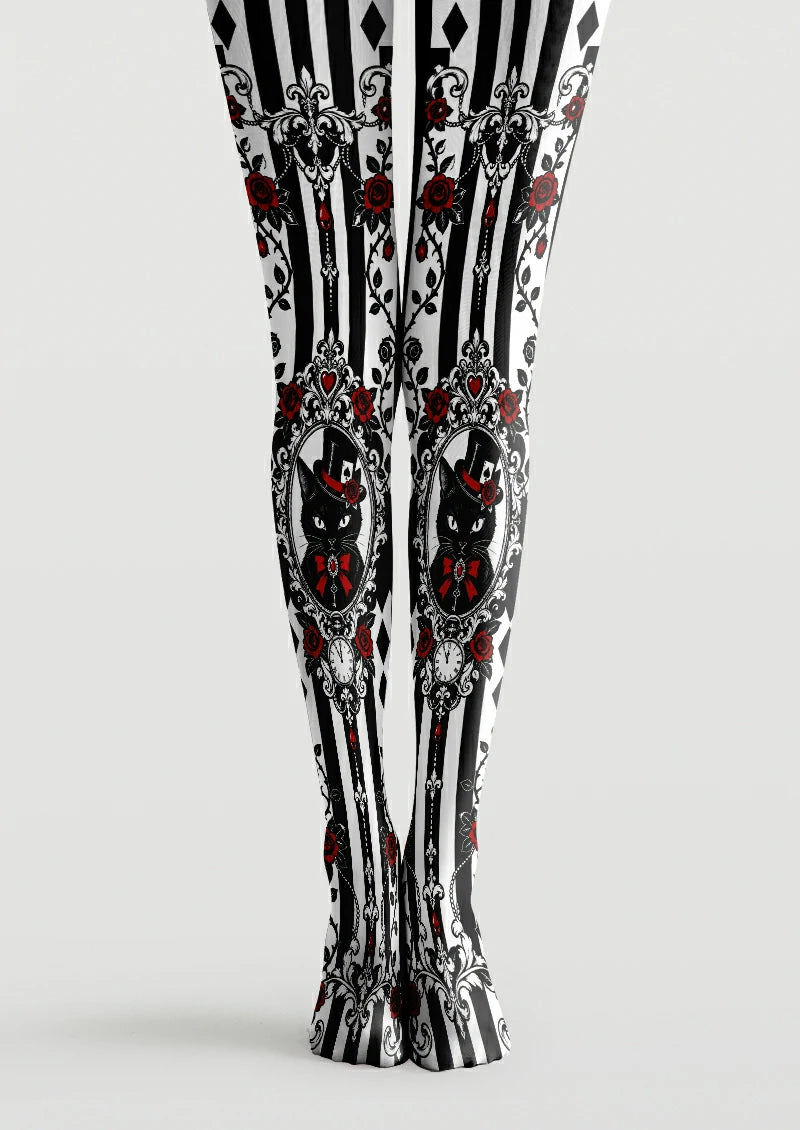 Black and white printed tights with ornate cat portraits, red roses, bows, and striped panels