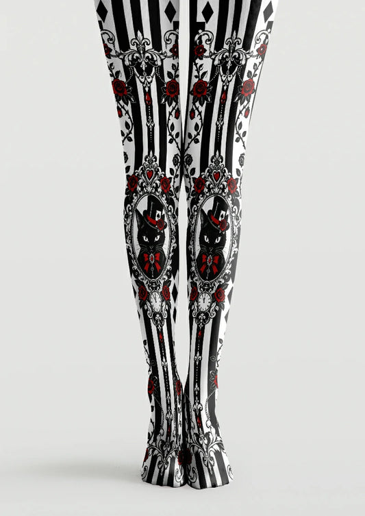Black and white printed tights with ornate cat portraits, red roses, bows, and striped panels