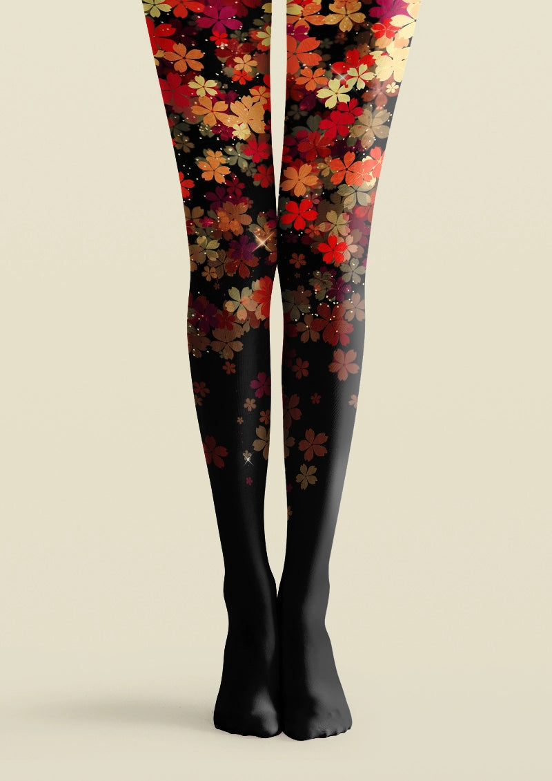 Black printed tights with layered red, orange, pink, and brown floral pattern cascading down the legs