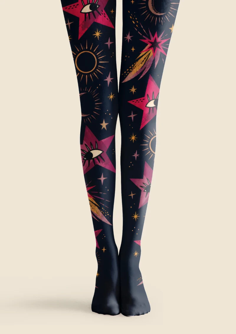 Black tights with pink eye-centered stars, crescent moons, bronze sun outlines and sweeping comet motifs