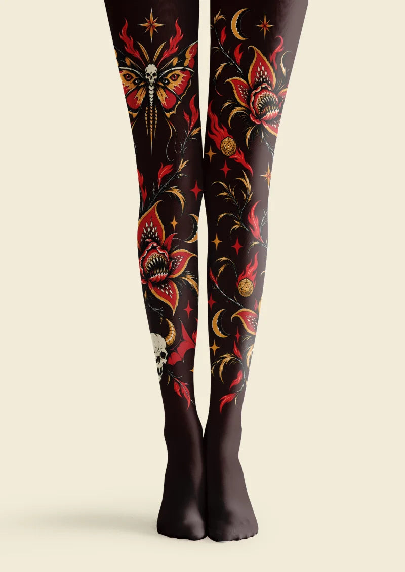 Black tights with red and orange skull moth, toothed flower, crescent moon, star, and botanical motifs