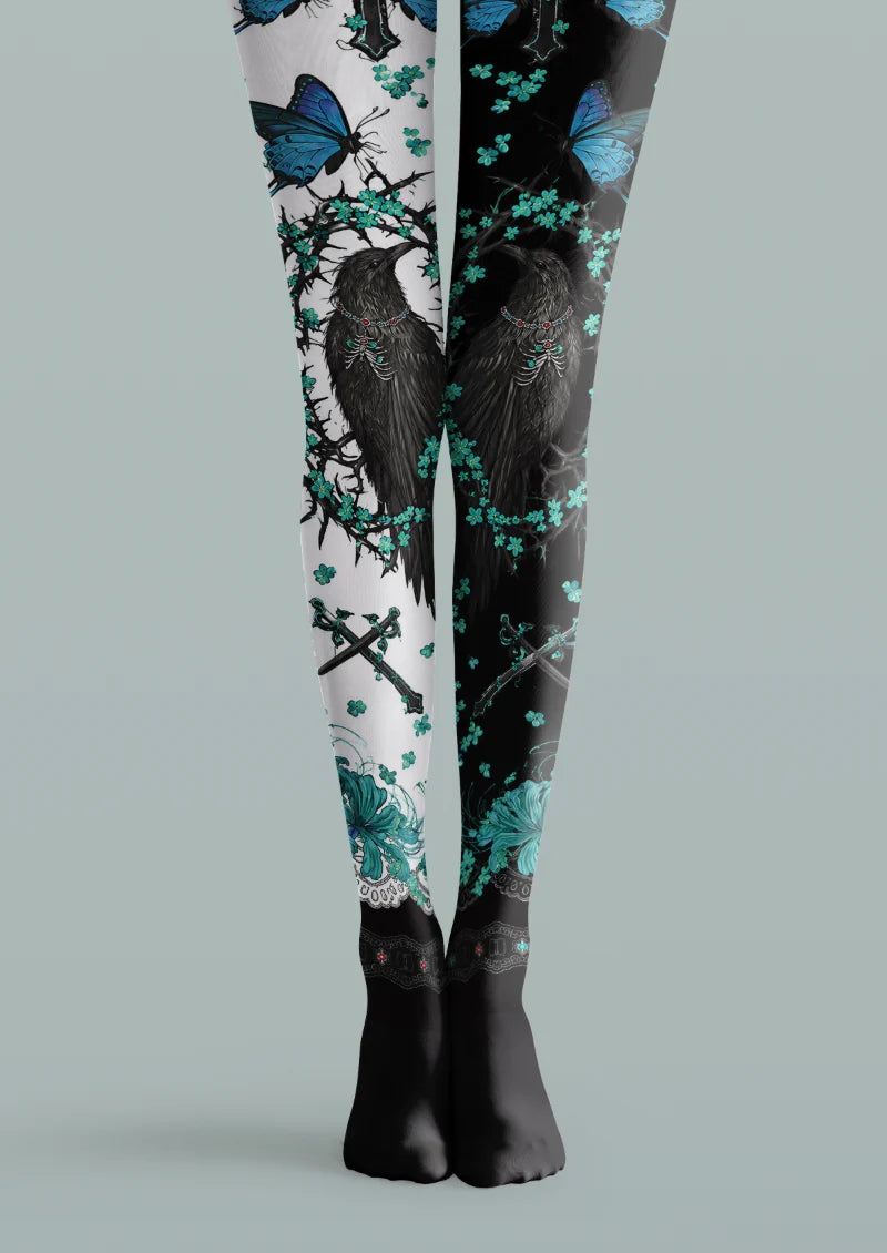 Black and white printed tights with black ravens, blue butterflies, turquoise flowers, crossed swords and black feet.