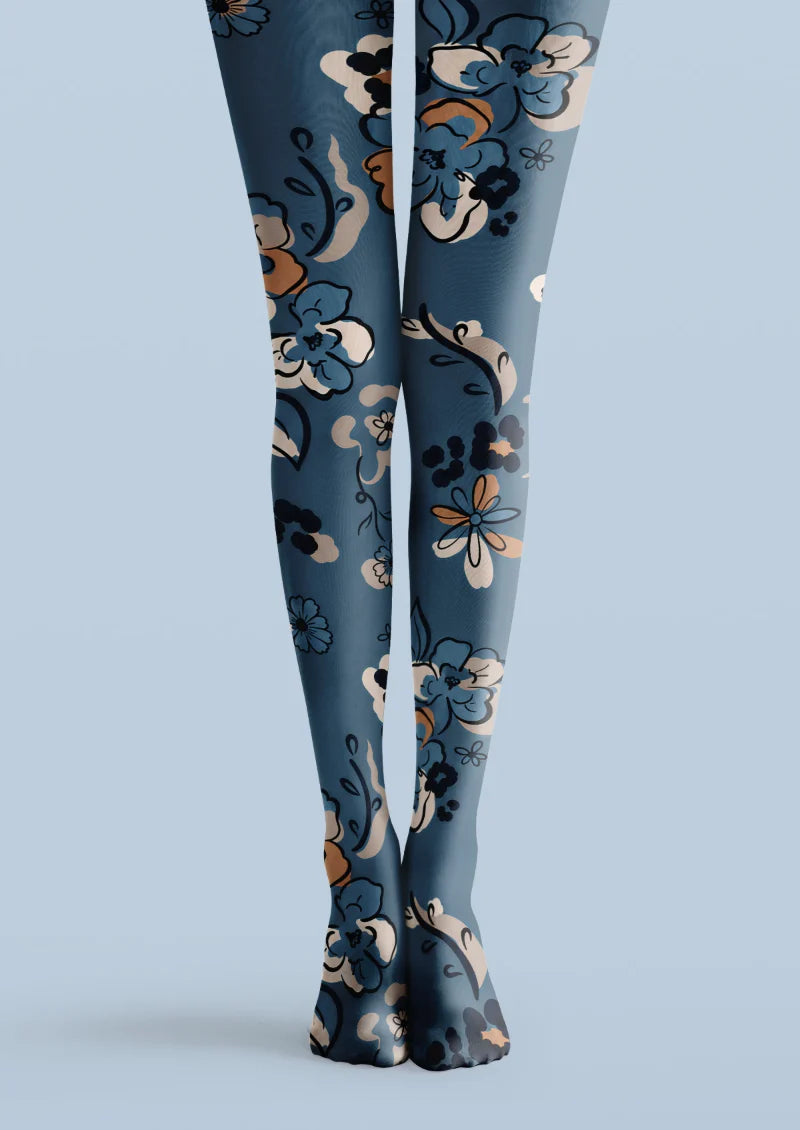 Blue printed tights with cream flowers, black outlines, orange accents, and decorative botanical stems.
