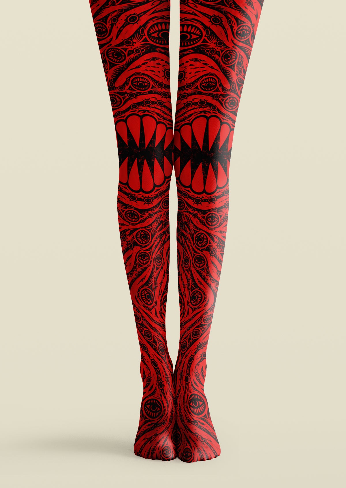 Red and black printed tights with repeating eye motifs, swirling linework, and a bold central mouth-like graphic.