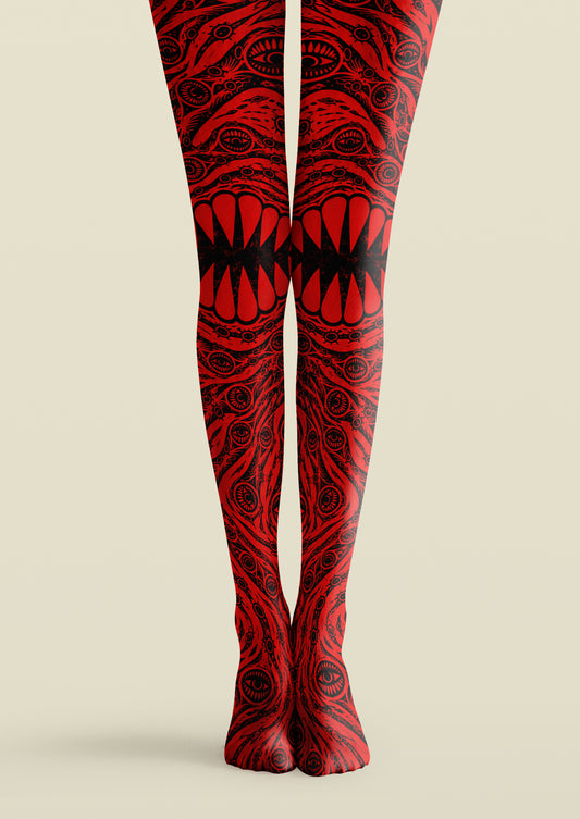 Red and black printed tights with repeating eye motifs, swirling linework, and a bold central mouth-like graphic.