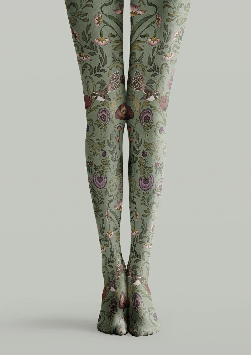 Green printed tights with brown flying birds, curling foliage, pink blossoms and purple flower details.