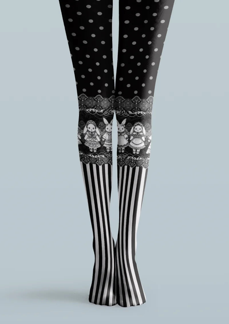 Black printed tights with gray polka dots, illustrated dolls and rabbits, ornate bands, and black-and-white vertical stripes.