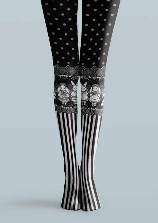Black printed tights with gray polka dots, illustrated dolls and rabbits, ornate bands, and black-and-white vertical stripes.