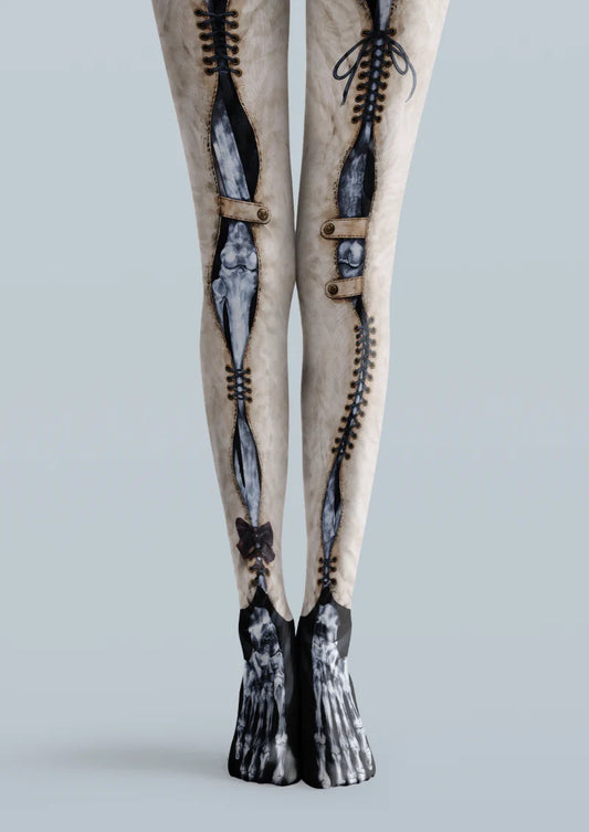 Beige printed tights with dark skeleton bones, black corset-style lacing, and bow details.