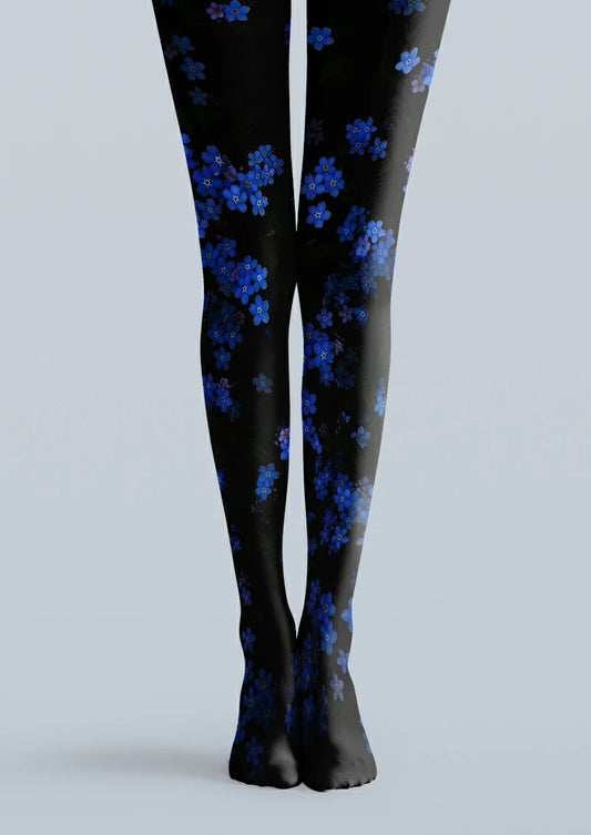 Black printed tights with scattered clusters of small blue flowers, pale yellow centres and dark leafy details.