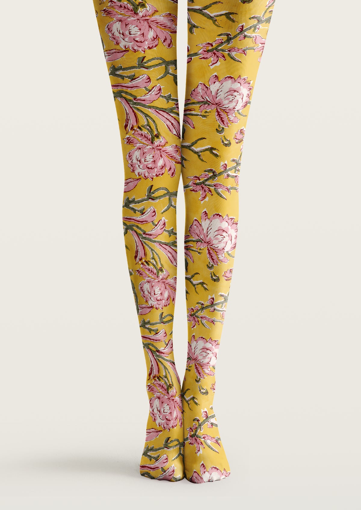 Yellow printed tights with pink floral motifs, green branches, leaves, and botanical patterns across both legs.