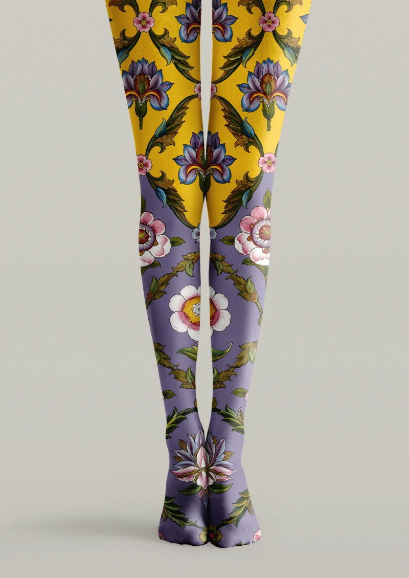 Yellow and purple printed tights with large multicolor flowers, green leaves, and scrolling botanical details