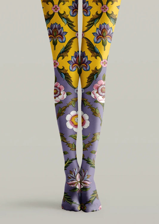 Yellow and purple printed tights with large multicolor flowers, green leaves, and scrolling botanical details