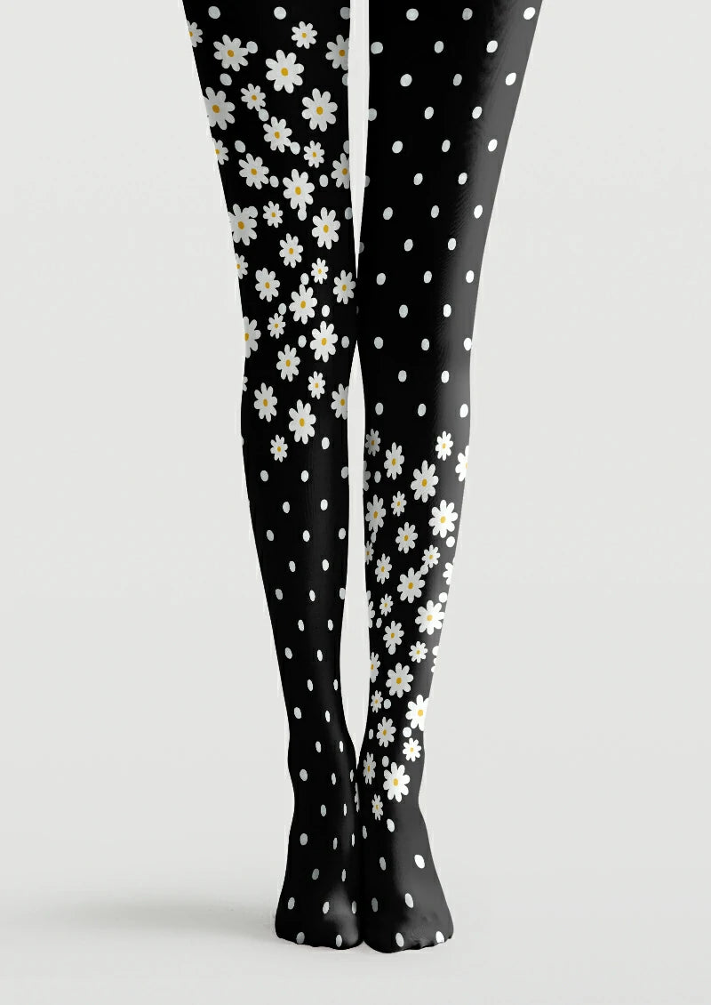 Black printed tights with asymmetrical white daisy clusters, yellow centers, and scattered polka dots