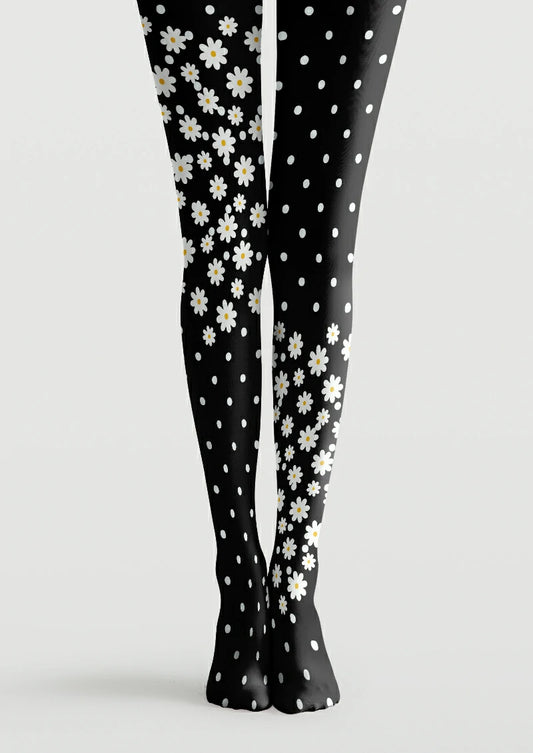 Black printed tights with asymmetrical white daisy clusters, yellow centers, and scattered polka dots
