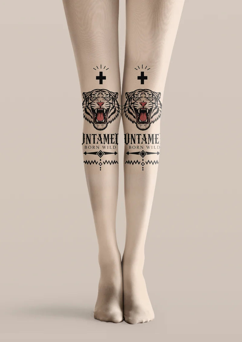 Beige printed tights with roaring tiger heads, black crosses, bold lettering, and geometric tattoo-style accents