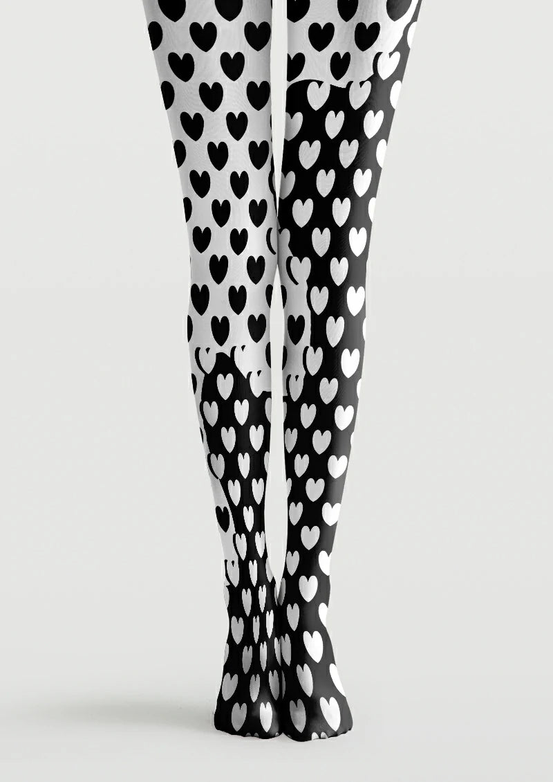 Black and white printed tights with repeating hearts, reversed colours and curved boundaries between light and dark areas.